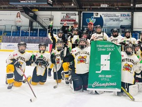 Members of the Mitchell U13LL hockey team celebrate after winning five consecutive games, including a 6-2 win over Listowel in the 'A' final, to win the Regional Silver Stick championship in Collingwood Dec. 11.
