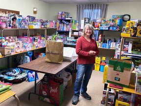 Volunteer helper Juanita Power stands amidst just one room that's full of donations the community has donated to the West Perth Community Christmas Care food and toy initiative this holiday season. There are "many moving parts" to make the project work, but the need is there, as more than 100 families have registered.