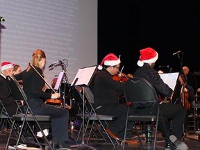 From a gaily decorated conductor's podium to red Santa hats on players and instruments, Quinte Symphony went all out for its Making Spirits Bright Christmas concert Saturday afternoon. JACK EVANS PHOTO