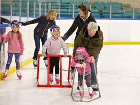 Ryan Haynes of Brantford helps his granddaughter Reese Hill, age 2 of Delhi as she learns to skate.  A free public skate was offered on New Year's Eve at Talbot Gardens arena in downtown Simcoe.