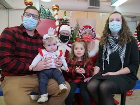 Steve and Brittany Beedham and their children, Hadley and Harper, pose with Santa and Mrs. Claus Sunday morning during the festive Polar Express event at Lansdowne Children's Centre in Brantford. CHRIS ABBOTT