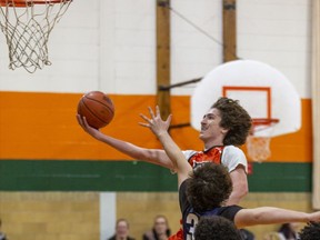 Chris Hager of the North Park Trojans rises to lay a shot up to the hoop during a high school senior boys basketball game against the Assumption Lions on Tuesday. Brian Thompson/Brantford Expositor/Postmedia Network