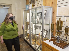 Tina Lyon, curator at the Paris Museum looks at a 1901 factory whistle from Paris Kitchens, part of an exhibit at the museum located in the Syl Apps Community Centre in Paris, Ontario. The whistle was retired after 50 years of use and presented to then-president E.M. Harold and vice-president J.A. Harold.