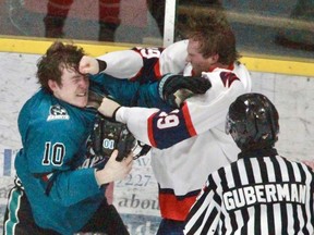 Reid Oliver (left) of the Stratford Warriors and and Chase Ellis of the Brantford Bandits fight during the second period of Friday's GOJHL game in Stratford. CORY SMITH / Postmedia