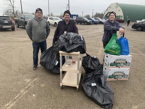 Nick Amy (left), Tom Waldschmidt and Nick Waldschmidt, of the Brant County fire department, were among the 100 volunteers, including Brant OPP and Brant Brantford Paramedics, who helped out with this year's Paris Community Christmas Toy and Hamper program.  Hampers were picked up at the Paris fairgrounds by Brant County families in need on Friday.  Vincent Ball