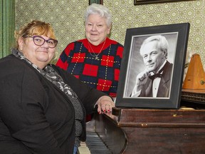 Amy Groleau (left) and her mother Jane Pritchard with a portrait of Don Pritchard, a beloved Brantford vocalist who passed away September 18, 2022.