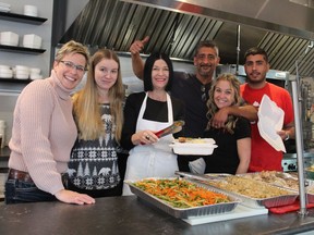 Steph Stock, Hannah Heard, Tammy Hunt, DJ Grierson, Ray Padamsey and Julian Padamsey were behind the counter on Christmas Day at Honey's Bistro on Brant Avenue serving free turkey meals to anyone who showed up. MICHELLE RUBY