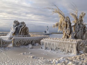 The Fishermen's Memorial statue at Port Dover, Ontario -- and everything around it -- are encrusted with ice just after sunrise on Christmas Day after a winter storm raged throughout most of the province over the past several days.