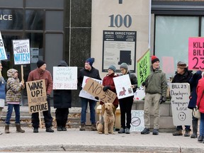 Protesters opposed to Bill 23 picket in front of Steve Clark's Brockville constituency office on Sunday afternoon, Dec. 4, 2022. (RONALD ZAJAC/The Recorder and Times)