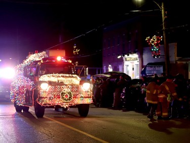 Members of the Augusta Fire Department hand out candy to the kids ahead of their brightly-decked fire truck. (RONALD ZAJAC/The Recorder and Times)