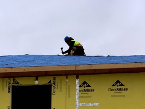 Workers continue with the roof of the St. Vincent Apartments building Thursday afternoon, Dec. 15, ahead of the coming snowstorm. (RONALD ZAJAC/The Recorder and Times)
