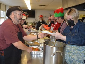 King's Kitchen volunteers fill Christmas dinner plates at South Grenville District High School in Prescott on Sunday. It was the first time in three years and since the onset of the pandemic that the annual event could be staged in the school cafeteria. 
Tim Ruhnke/The Recorder and Times