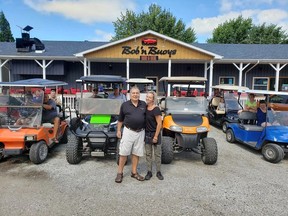 In this file photo from 2020, Dimitar Ljomov, left, chef at Bob 'n Buoys Bar and Boil, and restaurant manager Sherrie Dawson, are shown with golf cart owners at the Mitchell's Bay establishment. At the time, a petition was circulating in Mitchell's Bay calling on Chatham-Kent council to allow golf carts on local roads. During the Dec. 5 meeting, council voted in favour of lobbying the province for inclusion in a golf cart pilot project. Handout