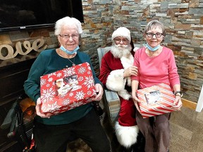 Village on the Thames residents Norma Wright, left, and Sally Clements enjoyed a visit from Santa Claus Thursday, who delivered gifts and greeting cards from the Seniors for Santa program. (Ellwood Shreve/Chatham Daily News)