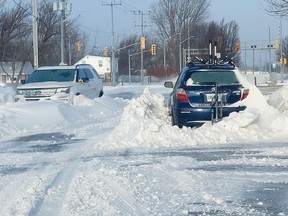 These two vehicles stuck in snow banks on Keil Drive South in Chatham from Friday's severe winter storm are among the reasons the Municipality of Chatham-Kent has declared as state of emergency. PHOTO Ellwood Shreve/Chatham Daily News