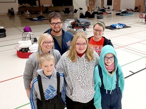 The Hoekstra family, including from back left, Rachel and Joel Hoekstra, Joel's sister, Janelle Hoekstra, and children, from front left, Micha, 9, Hayley, 13, and Kailyn, 11, were among the many local residents who volunteered to help people. Stranded in Friday's massive winter storm as they arrive at Chatham Christian School. (Ellwood Shreve/Chatham Daily News)