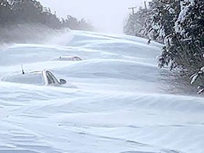 Local resident Rick Ellis sent this photo to the Chatham Daily News that he took Saturday morning of a massive snow drift on Harwich Road, south of Chatham, that buried some vehicles. PHOTO Contributed Rick Ellis