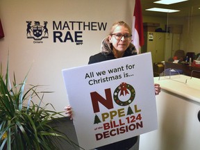 Treena Hollingworth, president of Canadian Union of Public Employees Local 4727 that represents Huron-Perth Healthcare Alliance workers, delivers a special Christmas card to the Stratford office of Perth-Wellington MPP Matthew Rae Thursday morning. The card is part of a provincewide campaign by CUPE and other hospital-worker unions in the province urging the provincial government not to appeal the Ontario Superior Court's recent decision striking down Bill 124. Galen Simmons/Postmedia