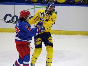 Colts speedy forward Bradley Fraser collides with Sweden's Axel Landen.  Photo taken Thursday, Dec. 8, 2022, in Cornwall, Ont.  Todd Hambleton/Cornwall Standard-Freeholder/Postmedia Network