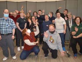 Participants of Beyond 21's Hear My Voice program, some joining from Holy Trinity Catholic Secondary School, and staff members strike a pose on Tuesday December 13, 2022 in Cornwall, Ont. Shawna O'Neill/Cornwall Standard-Freeholder/Postmedia Network