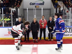 Robert Lefebvre/Hockey Canada Images
Canada West captain Liam Watkins, and U.S. captain Cole Knuble prep for the ceremonial faceoff from members of Dale Hawerchuk's family and former Cornwall Royals teammates prior to their game at the World Jr. A Challenge at the Cornwall Civic Complex on Sunday, Dec. 11, 2022.