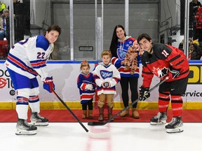 Robert Lefebvre/Hockey Canada Images
Cornwall Royals alumnus Dave Ezard's daughter Kristen, with her children, drop the ceremonial faceoff puck for Canada East captain Trent Crane, right, and U.S. captain Cole Knuble at World Junior A Challenge at the Cornwall Civic Complex on Wednesday, Dec. 14, 2022; they were invited as it was announced Ezard will be inducted into the QJMHL hall of fame in 2023.