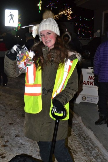 Trista Lambourn helps hand out candy to the kids along the Santa Claus parade route. Her mother, Kathy Beach Lambourn with the Foothills Fetal Alcohol Society collected the candy from the parade participants and bagged it for safety reasons. Photo by Dana Zielke