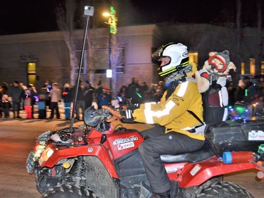 One Cool Pooch! with Foothills Search and Rescue hangs on for a ride in the Santa Claus Parade. Photo by Dana Zielke
