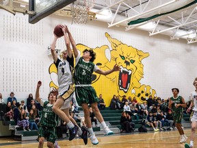 Bow Valley Bobcats Stirling King goes for a layup against Springbank Phoenix Akram Osman at Bow Valley High School in Cochrane on Wednesday, Dec. 14, 2022. The Bobcats beat the Phoenix 101-28.
