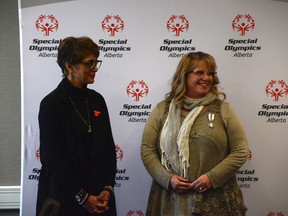 Jodi Flanagan stands alongside City of Calgary Mayor Jyoti Gondek after recieving her Platinum Jubilee Medal for being a major influence in figure skating for Special Olympians, as well as her years of service volunteering.