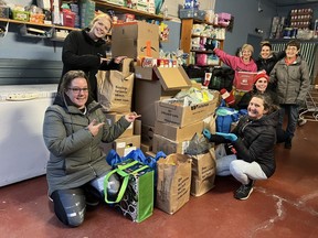Coach Melissa Wormington (front left) with coaches from NV Fitness Fit Body Boot Camp donating the 3,000 items to St. Vincent de Paul. Pat Clifford (back right) received this donation with open arms. Submitted
