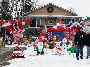 The Taylor family of 200 Spence Crescent in Mitchell, Ken (left), Kaylee, 13; Emersen, 11; Ashley and Jacob, 5, stand in front of their Christmas display of inflatable characters that completely covers their front lawn. They have 40 all told, and try to add to their display every year. ANDY BADER/MITCHELL ADVOCATE