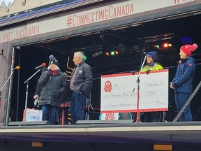 Susanne Quinlan, of Gleaner's Food Bank, accepts a cheque for $7,000 from CP Rail at the annual CP Holiday Train event in Belleville on Tuesday, November 29.