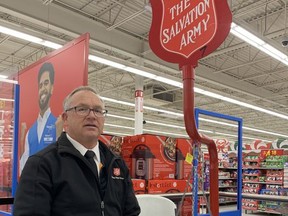 Major Curtis Butler, a volunteer with the Salvation Army, works the Salvation Army Kettle at the Belleville Walmart.