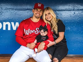 Taylor Cole relaxes with his wife, Madilyn, and daughter, Cozie, in the dugout of the Triple-A Worcester Red Sox last season.