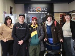 A new youth peer support program is being offered in Kingston in the new year via a partnership between United Way of Kingston, Frontenac, Lennox and Addington and Resolve Counselling. From left: Tara Everitt, Director of Community Services at Resolve Counselling, youth peer supporters Jake Staley, Zach Hartwick, and Charlie Lundy, and Resolve youth peer facilitator Danny McLaren pictured at Resolve Counselling in downtown Kingston on December 14, 2022. Meghan Balogh/The Kingston Whig-Standard/Postmedia Network