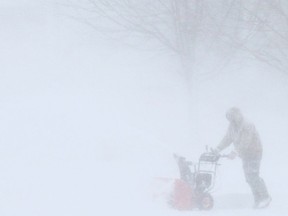 A west-end Kingston resident gets a jump on clearing their driveway Saturday, Dec. 24. Elliot Ferguson/The Whig-Standard.