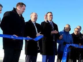 Pittsburgh District Coun. Ryan Boehme, from left, Kingston Mayor Bryan Paterson, Kingston and the Islands MP Mark Gerretsen and MPP Ted Hsu cut the ribbon at the opening of the Waaban Crossing across the Cataraqui River in Kingston, linking Highway 15 in the east to Montreal Street in the west.