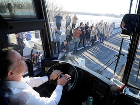 Shawn Geary, owner and president of McCoy Bus Service and Tours, drives the first vehicle across the Waaban Crossing over the Cataraqui River in Kingston on Tuesday, Dec. 13, 2022. The bridge links Highway 15 in the east to Montreal Street in the west.