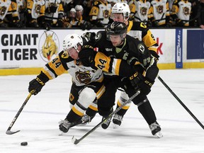 Kingston Frontenacs Shane Wright tries to get past Hamilton Bulldogs defenceman Nathan Staios while Logan Morrison backchecks during Ontario Hockey League action at the Leon's Centre in Kingston on Friday March 18, 2022. Ian MacAlpine/Kingston Whig-Standard/Postmedia Network