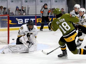 Kingston Frontenacs goatender Ivan Zhigalov makes a save on North Bay Battalion's Josh Bloom in Ontario Hockey League action at the Leon's Centre in Kingston on Friday, Dec. 2, 2022.