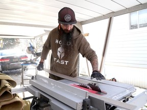 KI.Veterans_on_Wheels_member_Jamie_Gallant_cuts_vinyl_flooring_