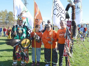 Some of the Grand Entry participants for the Second Annual "Every Child Matters" Pow Wow in Kirkland Lake on September 30 are from L-R: Head Male Dancer George Rose, Gavin Gill, Matachewan FN youth; Bertha Cormier, Executive Director of Keepers Of The Circle and Councillor Tom Fox, Matachewan FN. Photo courtesy of Xavier Kataquapit.