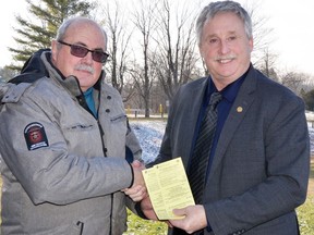 From left, Dave Frayne, chair of the Conservation Dinner Committee, sells the first Conservation Dinner tickets to South Huron Mayor George Finch. Tickets are now  available for purchase for yourself or as a seasonal gift. The Dinner Committee has announced the return of an in-person dinner and auction in 2023. The Conservation Dinner takes place Thurs., April 20 at South Huron Recreation Centre in Exeter.