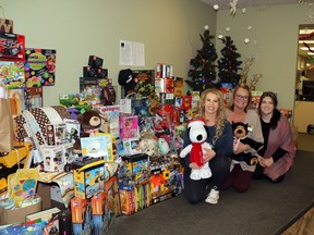 Abby McKillop, Heidi Adams and Shayden Lasher collected a haul of gifts at Grigg Insurance for the Mayerthorpe Food Bank, to go to the Christmas hamper.