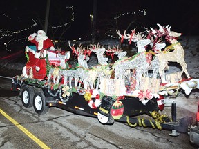 Photo by KEVIN McSHEFFREY
Santa Claus arrived in Elliot Lake Friday evening and rode down Ontario Avenue and waved at the many lining the street. Children cheered as they saw him arrive in his sleigh on a trailer.