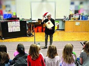 Sheena Read reads 'Twas the Night Before Christmas while showing students the jingling sounds produced by the reindeer's harness.
