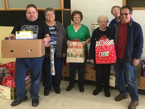 Pincher Creek Legion Branch 43 members and the Legion's Ladies Auxillary members organizing items for Christmas Hampers in 2016.