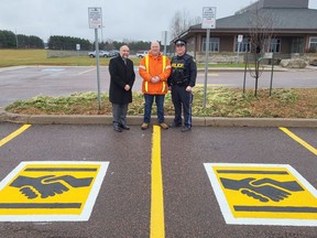 In the photo, standing by the specially marked 'internet purchase exchange zone' parking spots at the UOV OPP detachment are, from left, Pembroke Mayor Ron Gervais, City of Pembroke Roads and Fleet Supervisor Brad Faught, and Upper Ottawa Valley OPP Constable Darryl Graveline. OPP photo