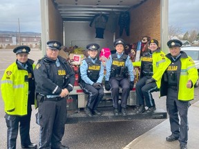 In the photo from left, Auxiliary Const. Noah Schroeder, Auxiliary Sgt. Paul Leeson, Auxiliary Const. Michelle Simms, Auxiliary Const. Avery Munro, Auxiliary Acting Sgt. Katie Yantha, Acting Auxiliary Staff Sgt. Antaire Lubitz with the cube van full of 'Stuff a Cruiser' donations.